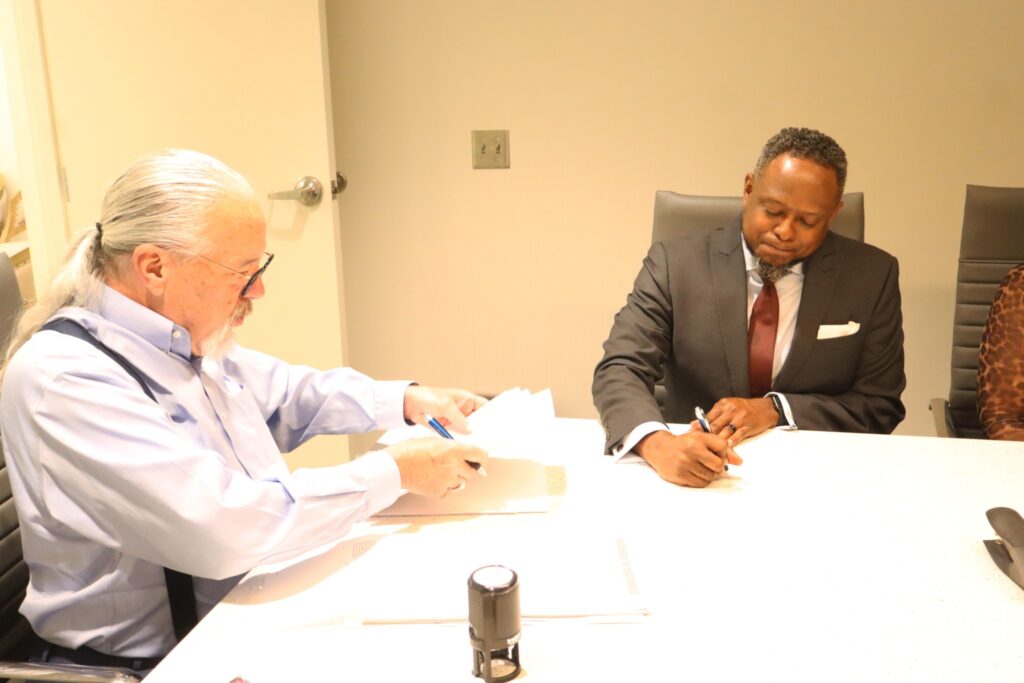 Bishop Jonathan L. Woods Sr. signing closing day papers